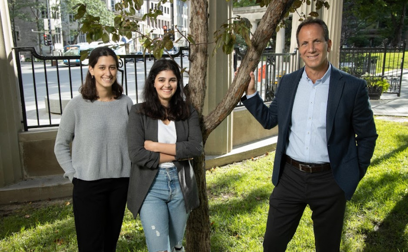 Two females and a male standing on McGill campus