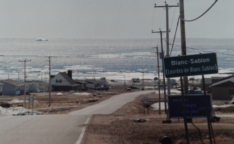 Paved road leading down to Gulf of St. Lawrence in Blanc-Sablon, Quebec