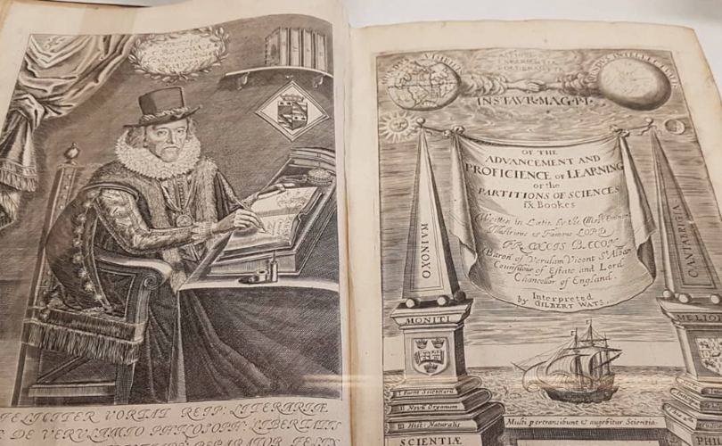 An old book with a picture of a person and a ship.