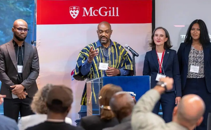 People gathered near a lectern at a launch event
