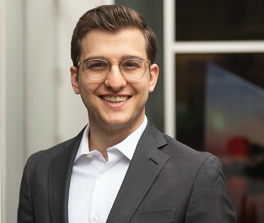 A man in a suit smiling