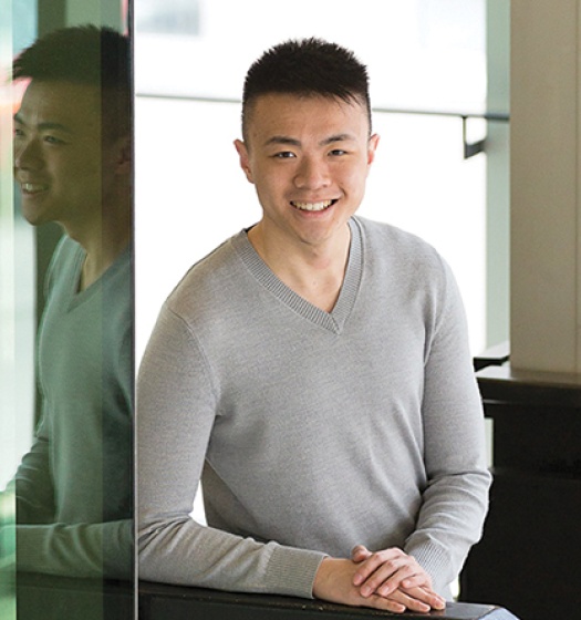 Student standing in front of glass mirrored walls