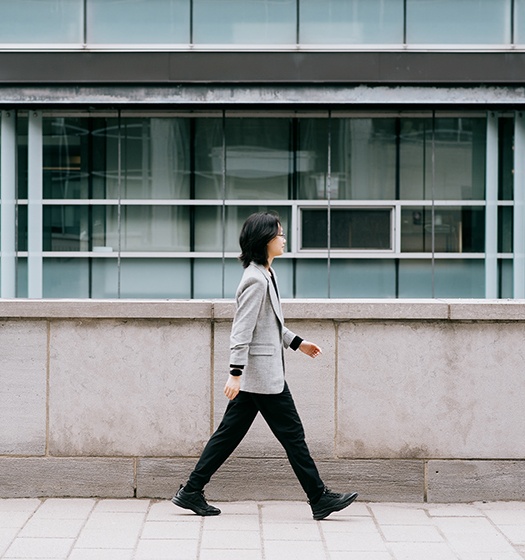 A person walking on a sidewalk