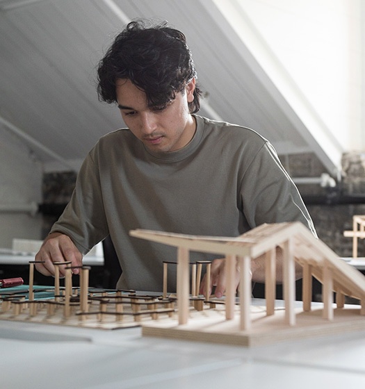 A person working on a model of a building