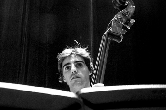 Man playing cello in black and white